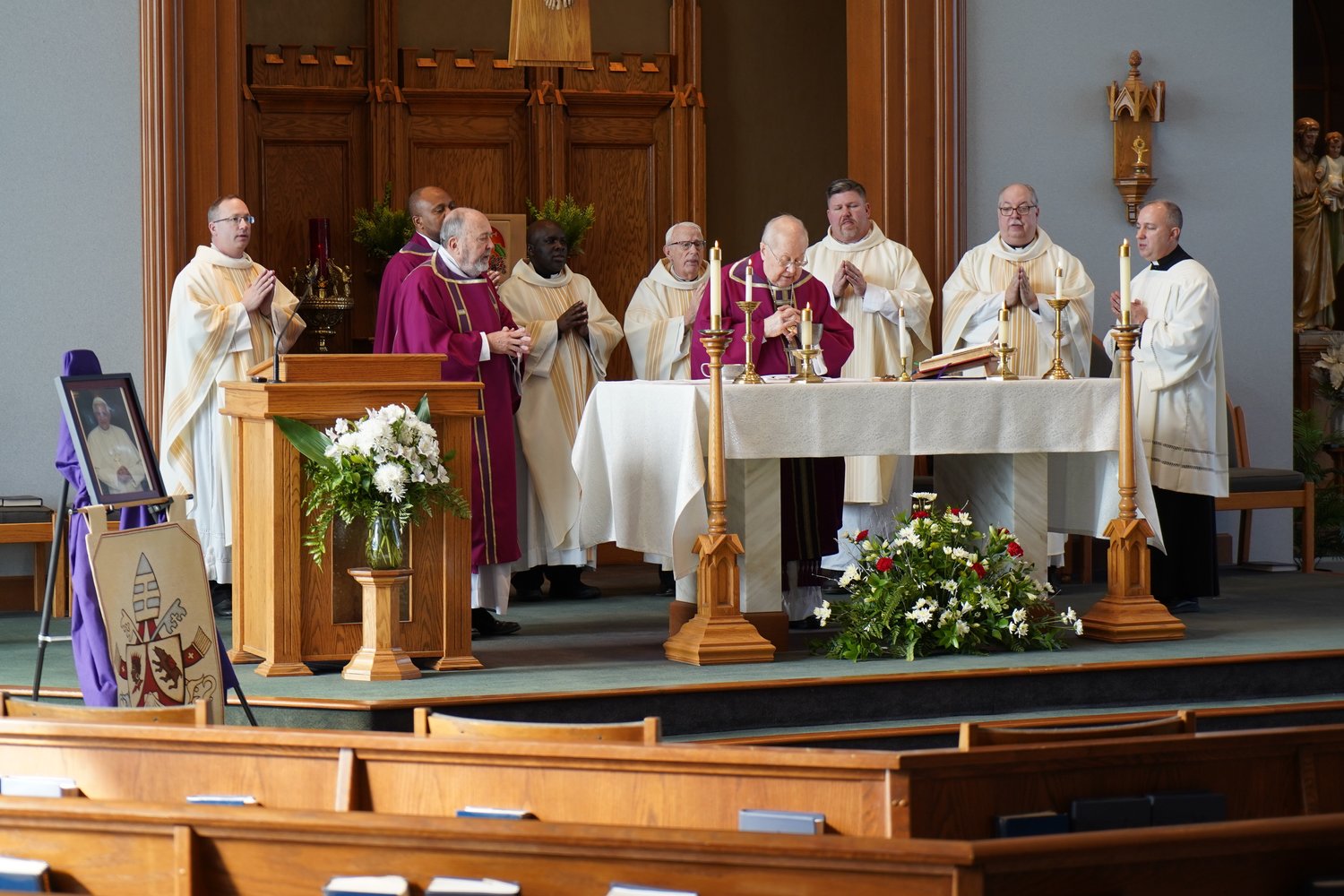 Bishop Emeritus John R. Gaydos, who led the Jefferson City diocese from 1997 to 2018, elevates the Most Blessed Sacrament (right) during the See City Deanery’s Memorial Mass for Pope Emeritus Benedict XVI on Jan. 6 in St. Andrew Church in Holts Summit.